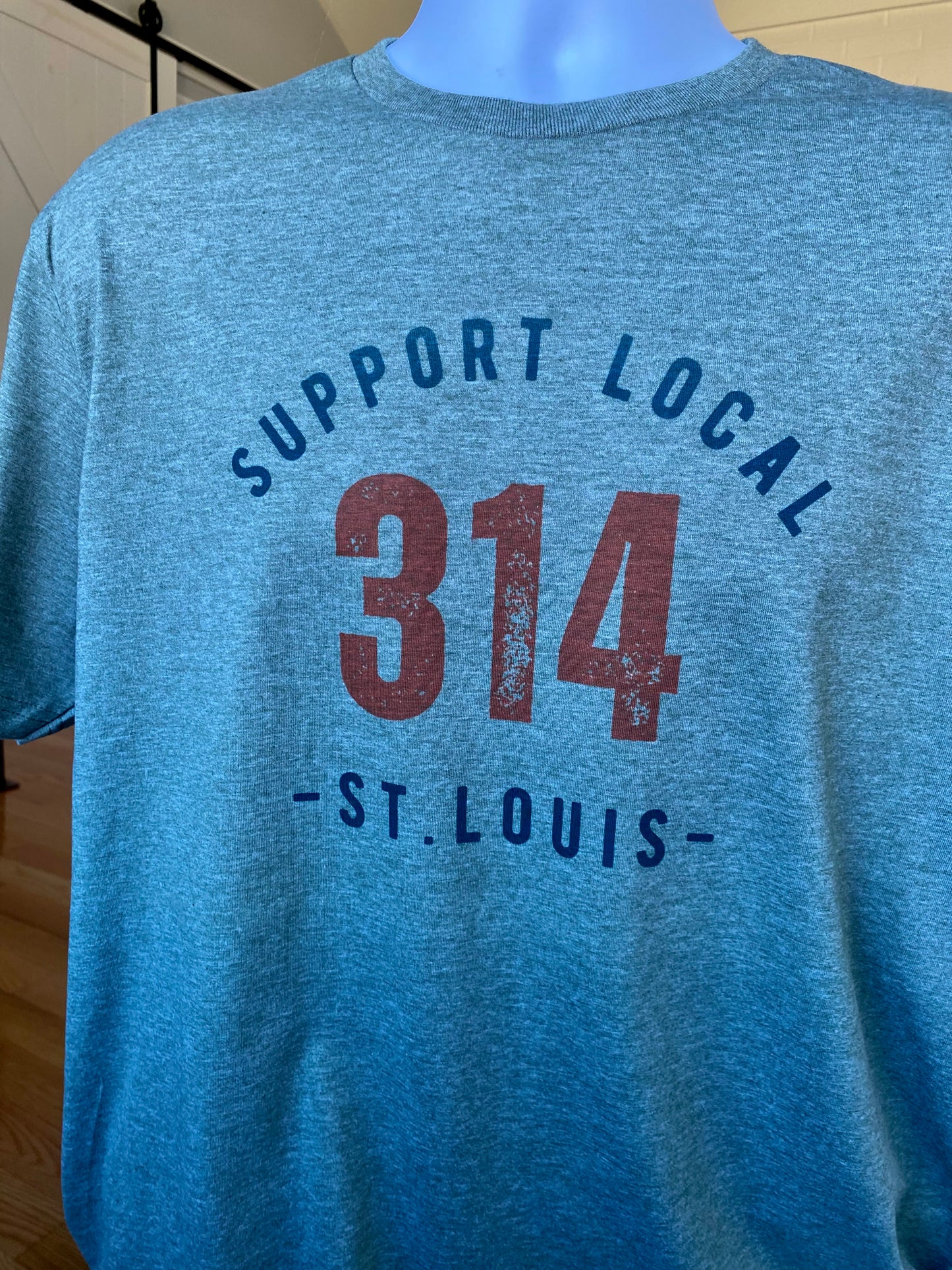 St. Louis T-Shirt (green) encouraging the community in St. Louis, Missouri to Support Local St. Louis in the 314 area code neighborhoods of the city through apparel.