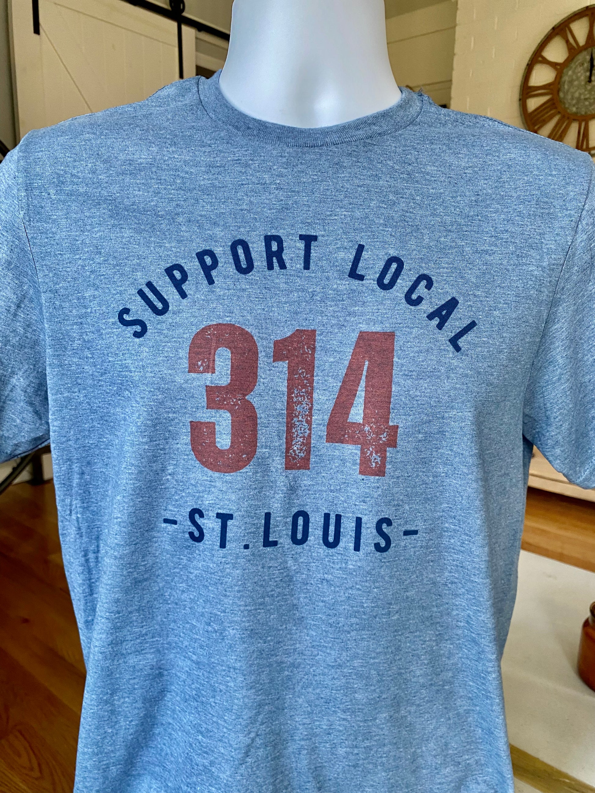 St. Louis T-Shirt (blue) encouraging the community in St. Louis, Missouri to Support Local St. Louis in the 314 area code neighborhoods of the city through apparel.